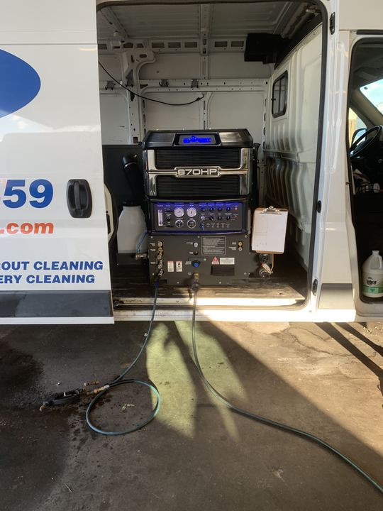 Stain Lifters van with side door open showing the truck-mounted 870HP
cleaning unit and hoses